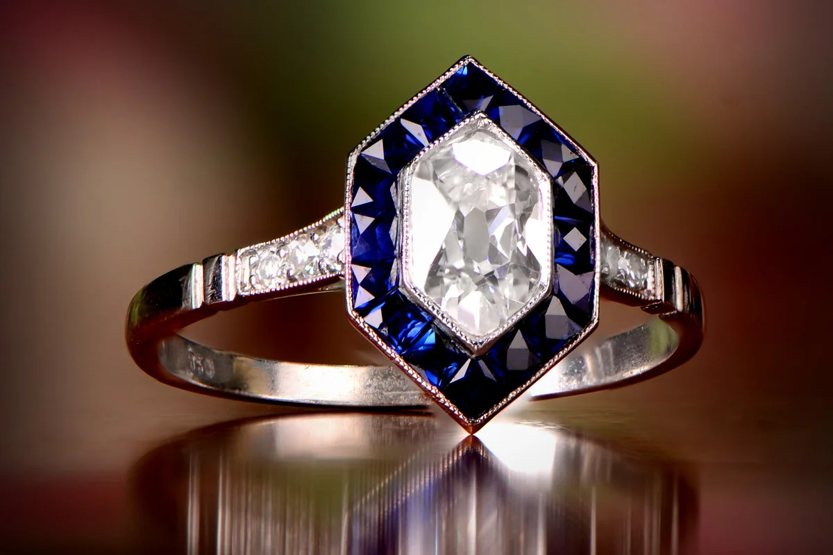 Antique kite-shape Diamond Engagement Platinum Ring with a Sapphire Halo