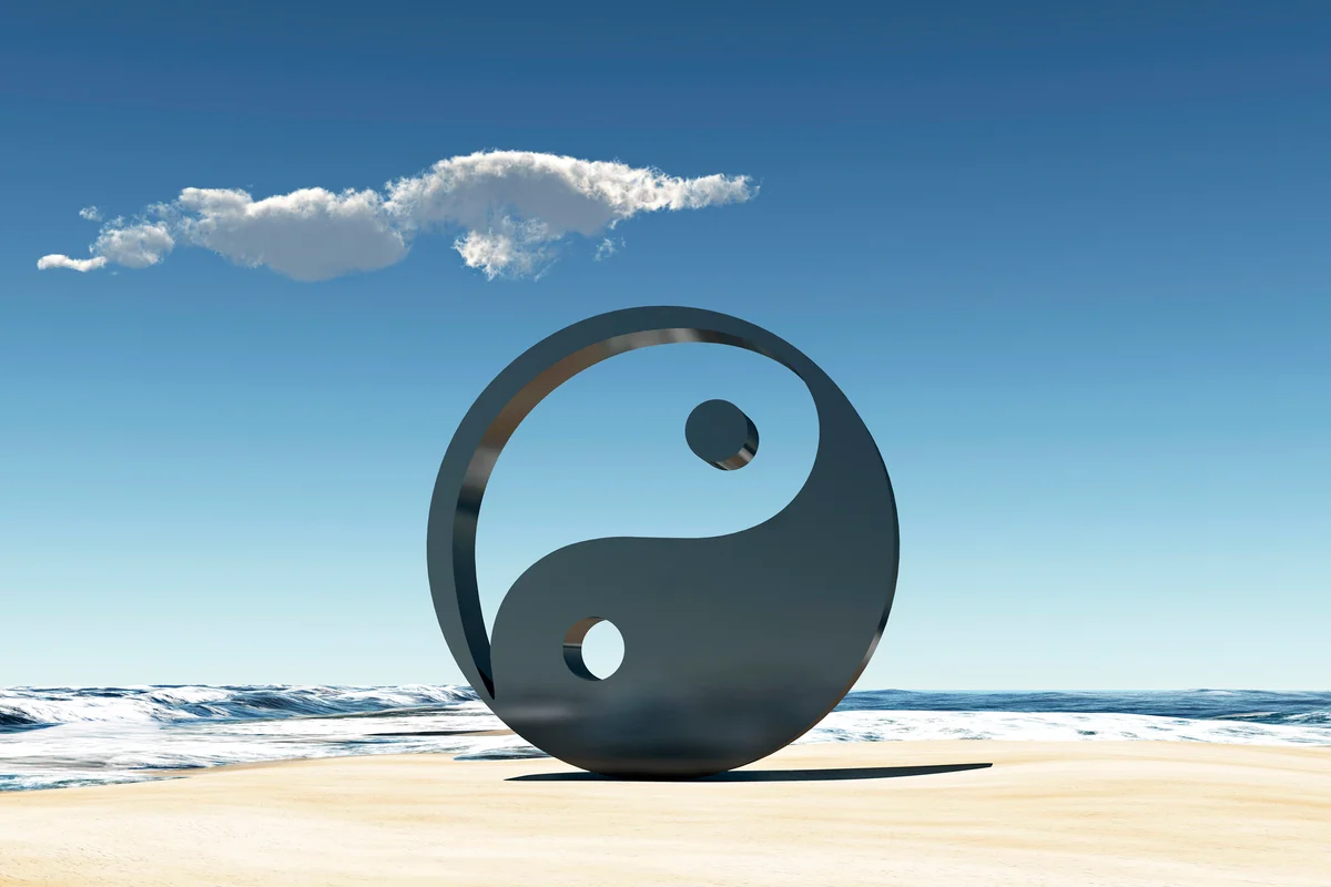 Yin and Yang Symbol on a beach at the sea