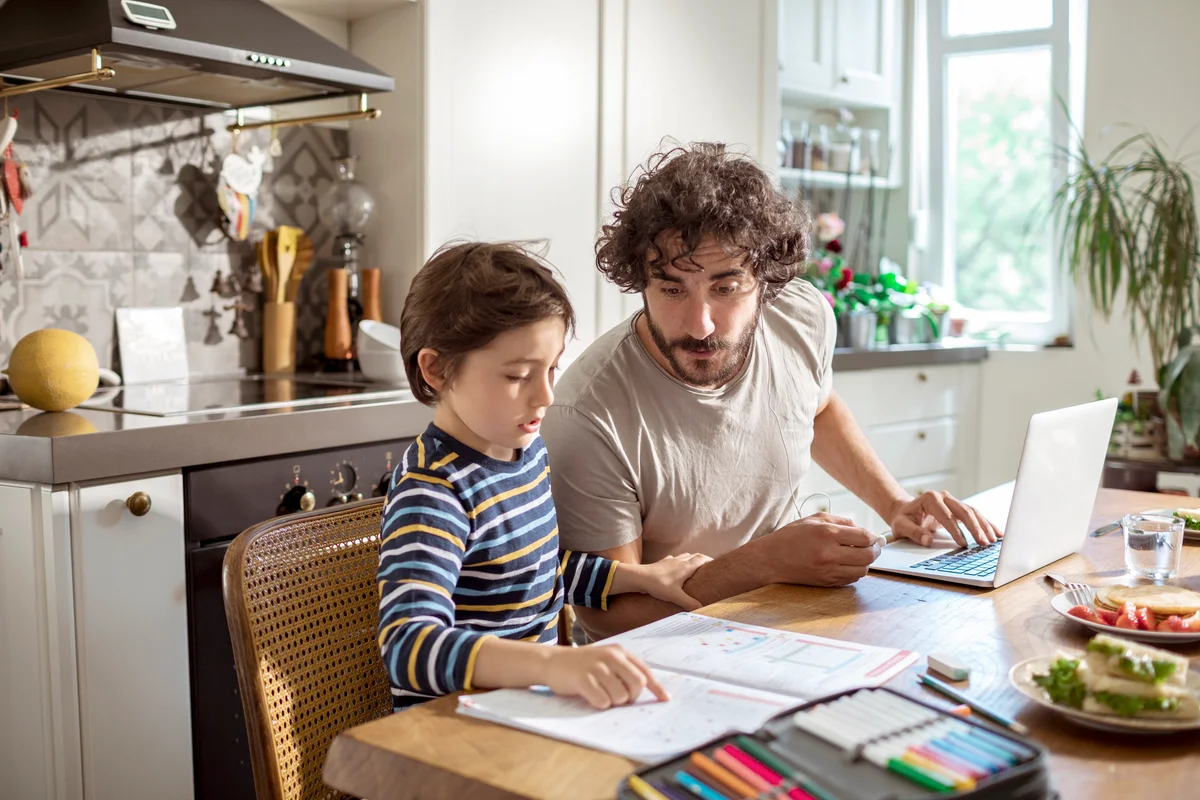 Step-father helping his son with schoolwork