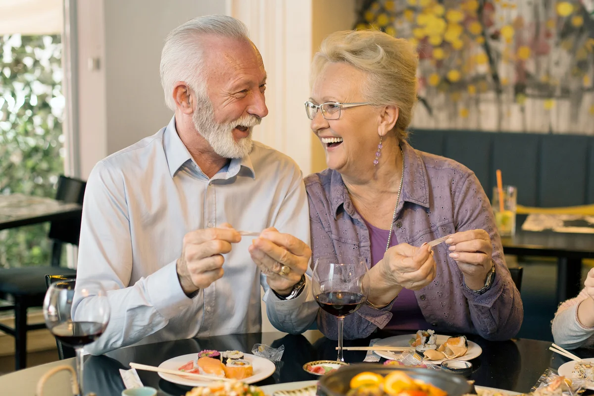 Senior couple opening fortune cookies