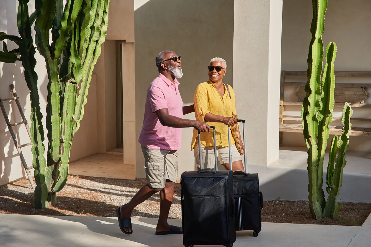 A mature couple arrive at a holiday retirement community