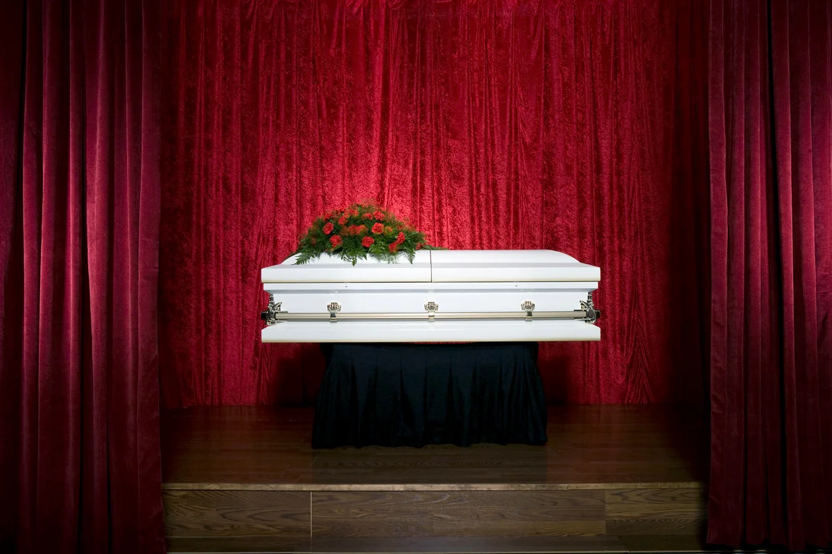 Coffin on red stage