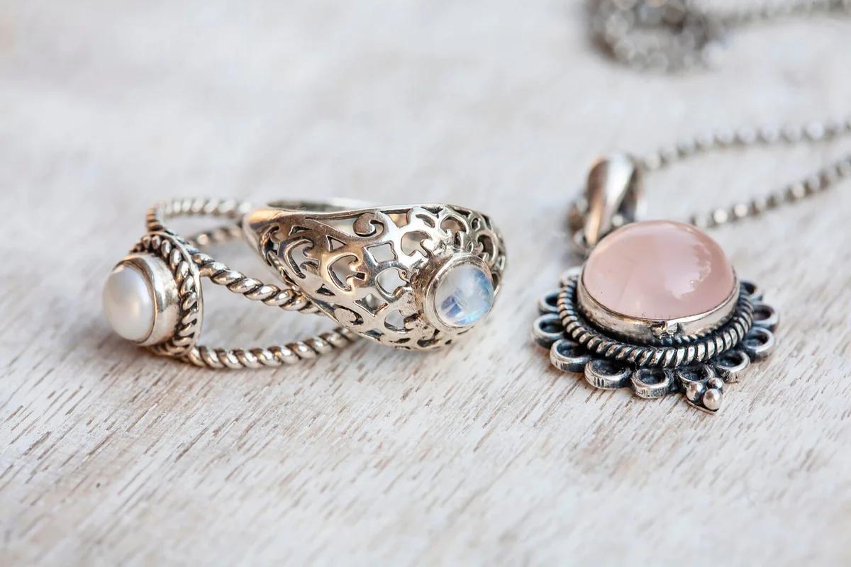 Silver jewelry on neutral bright wooden background