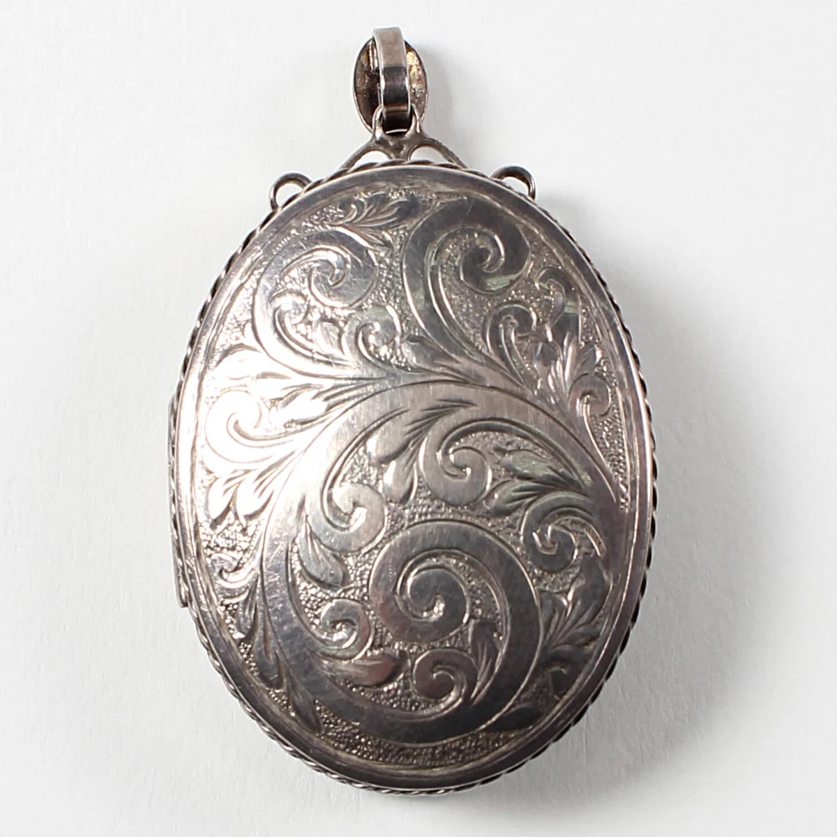 Silver locket belonging to Sir Edmund Hillary's grandmother containing a piece of Everest rock and note written by EPH's mother Gertrude in 195