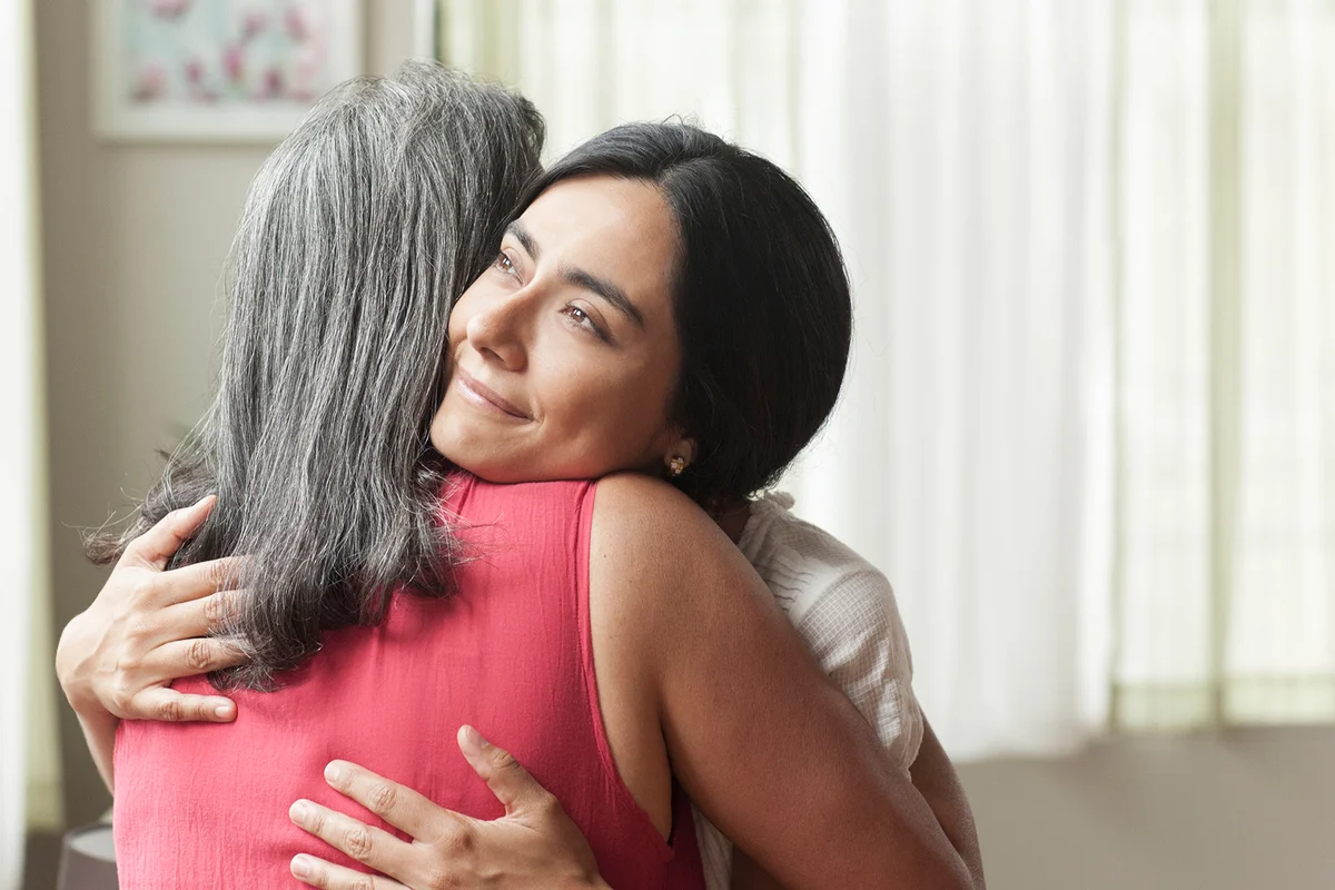 Smiling woman hugging mother-in-law