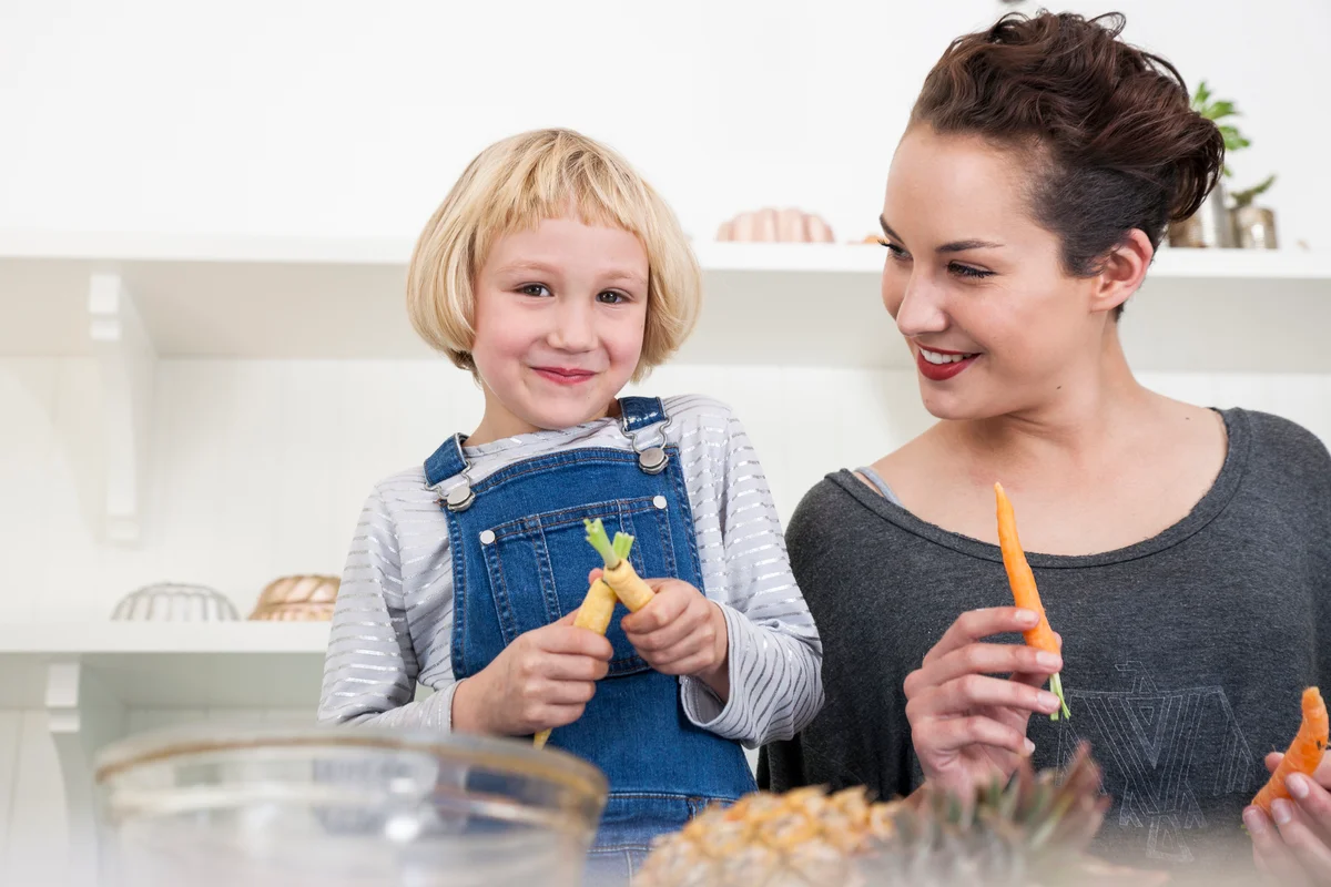 Woman and child in kitchen, preparing food
