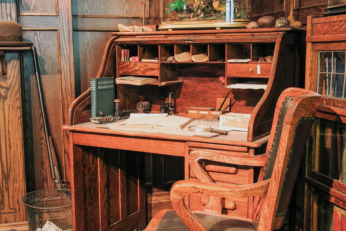A turn of the century old office table and chair