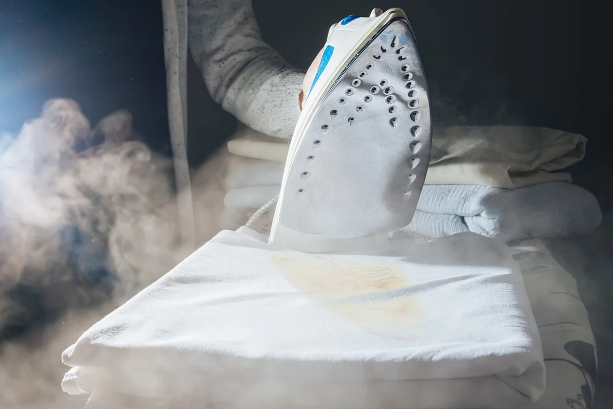 Woman Hands Ironing White Sheets