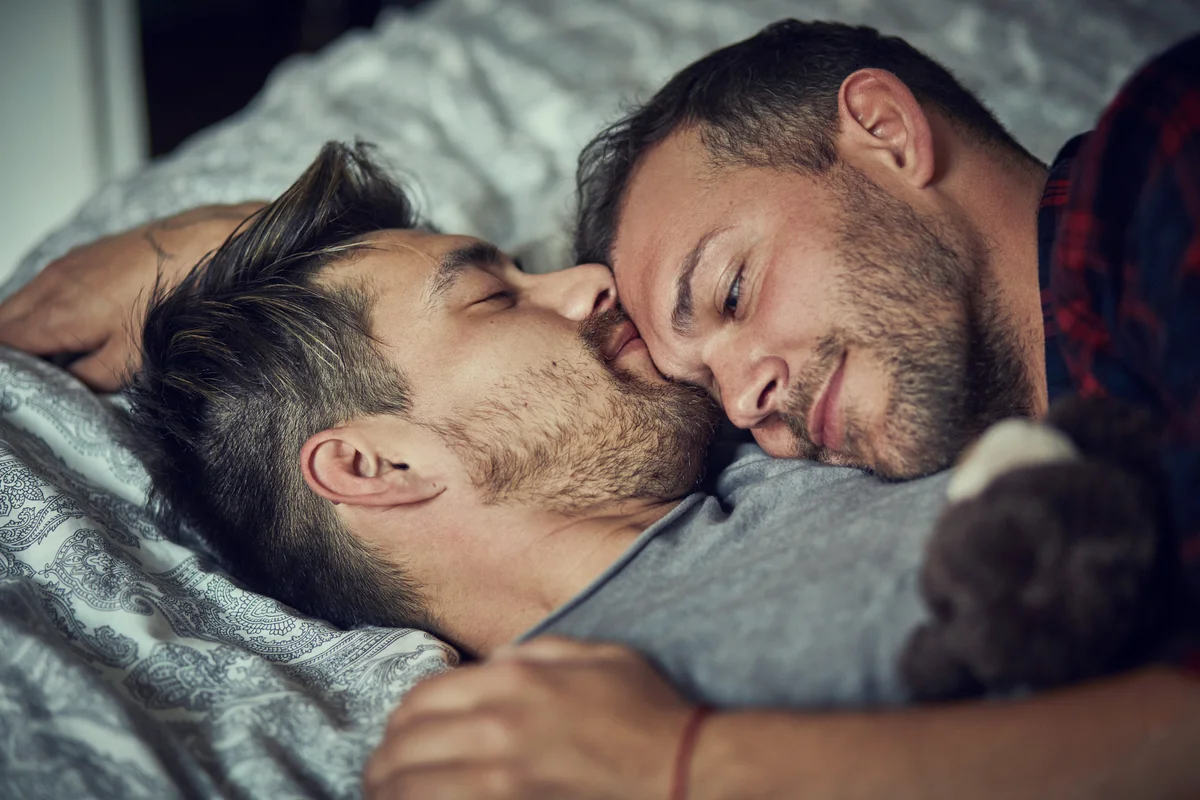 Cute couple lying in bed at home