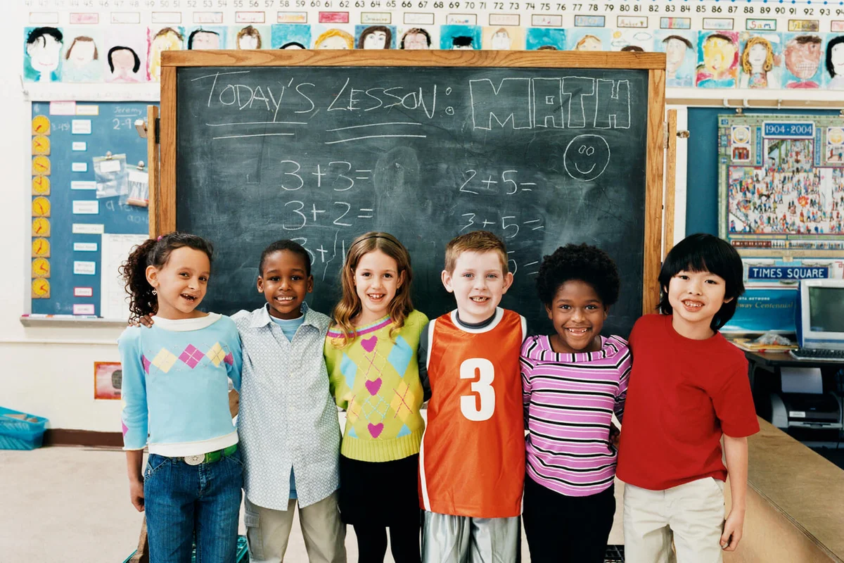 Portrait of Primary Schoolboys and Schoolgirls Standing in a Line in a Classroom