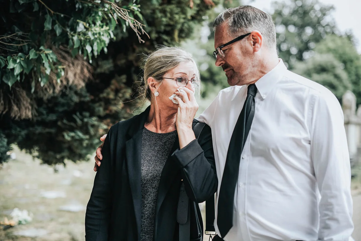 Husband trying to comfort his wife due to her loss