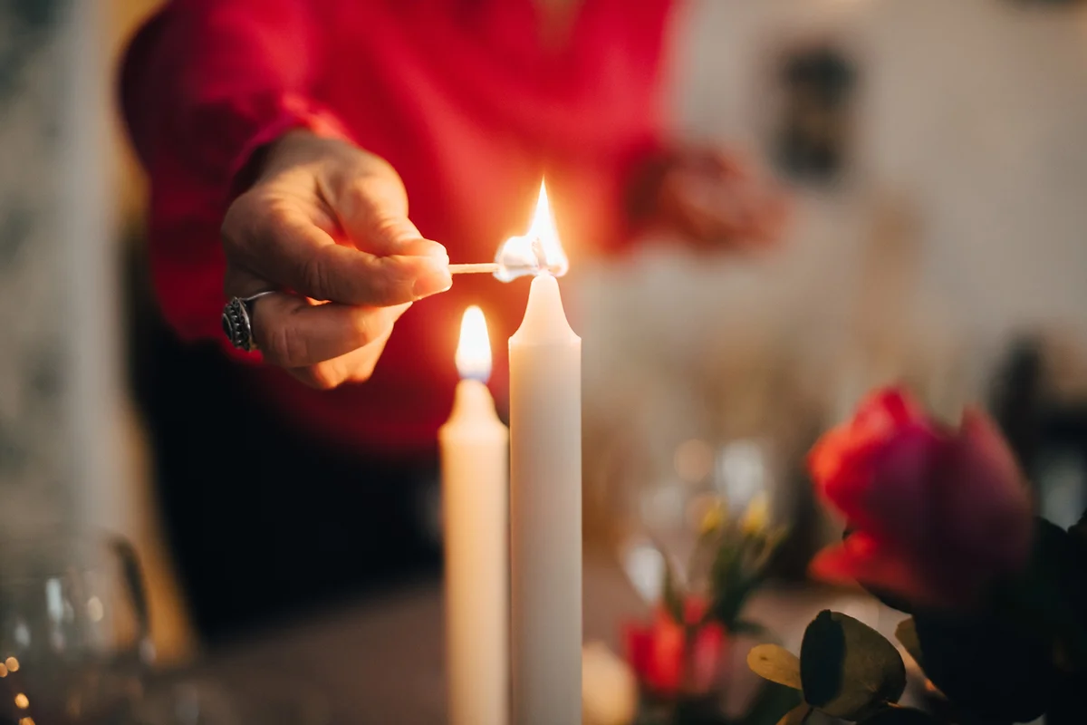 woman igniting candle