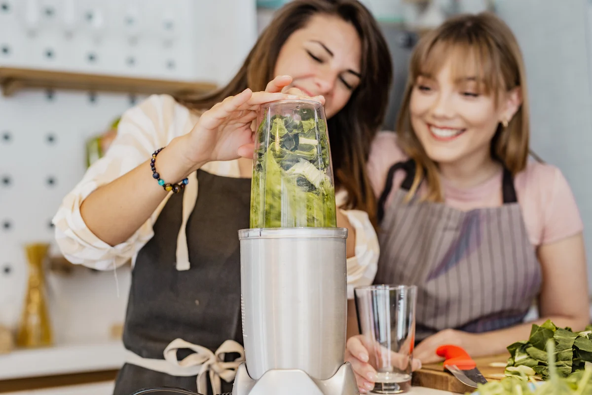Two friends blending healthy drink