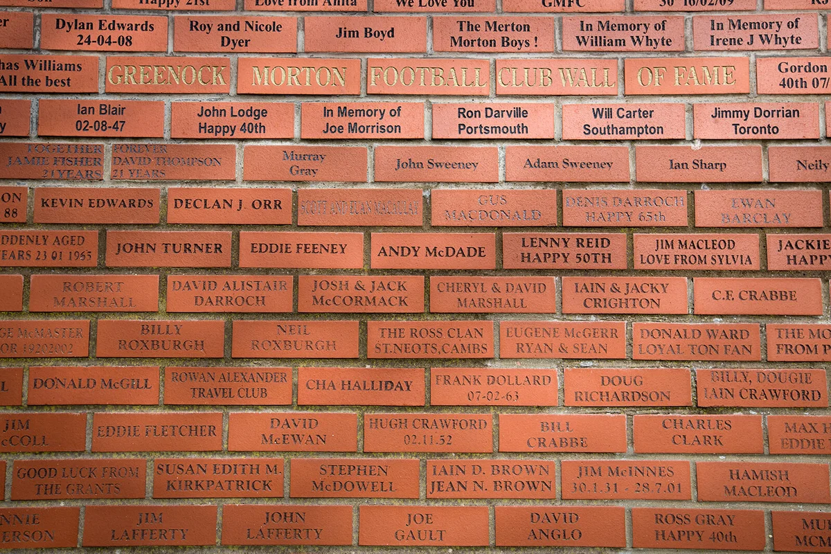 A red brick wall of fame with supporters names inside the stadium | Getty Editorial Use