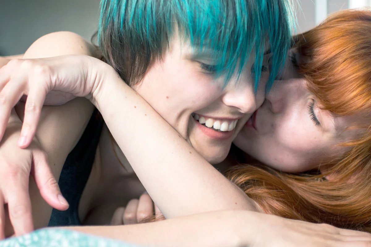 Happy Couple Lying On Bed