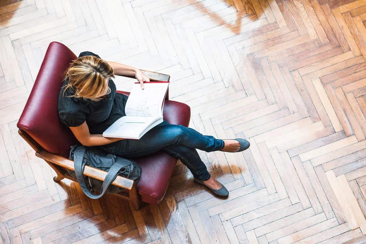 Female Student reading a book library
