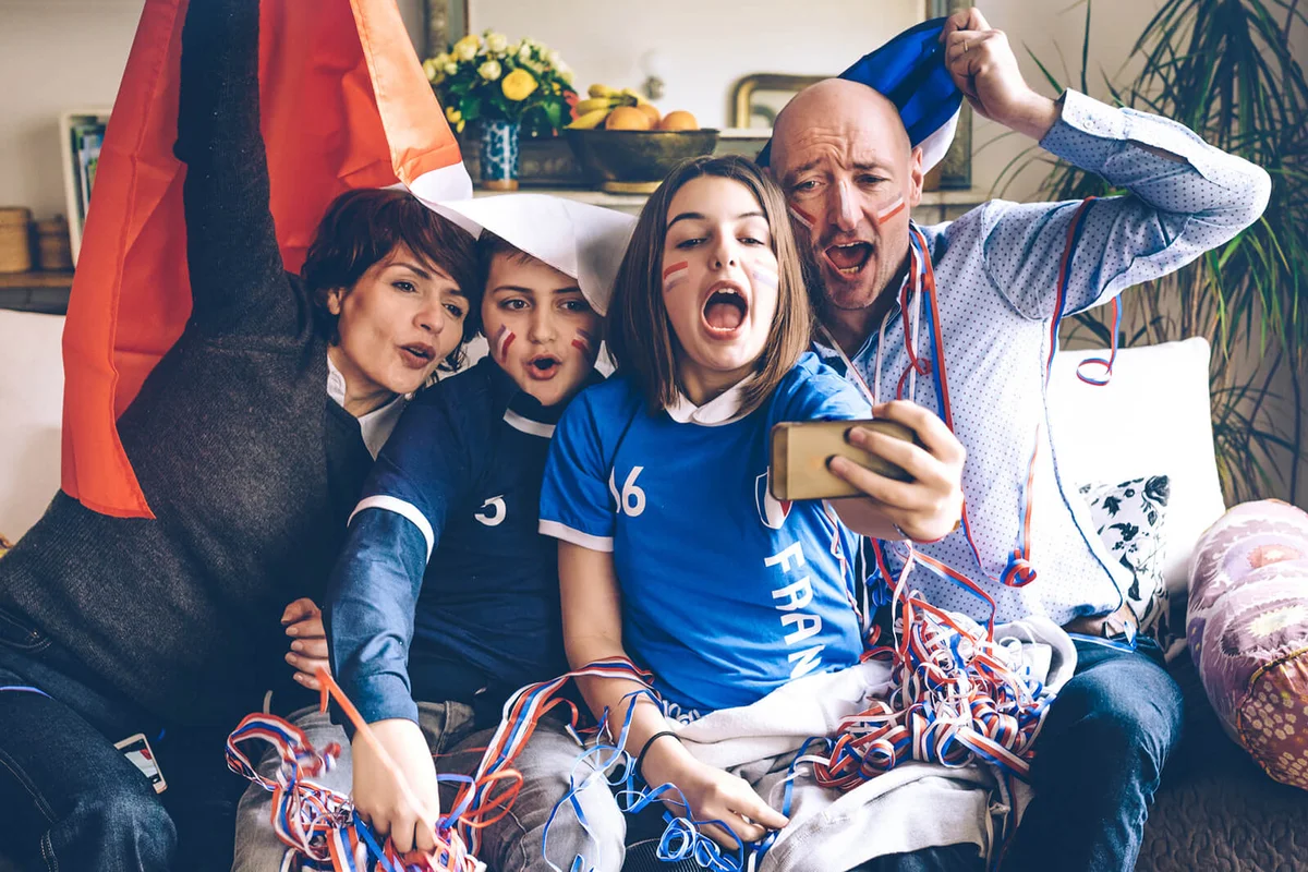 french family soccer fans watching soccer game
