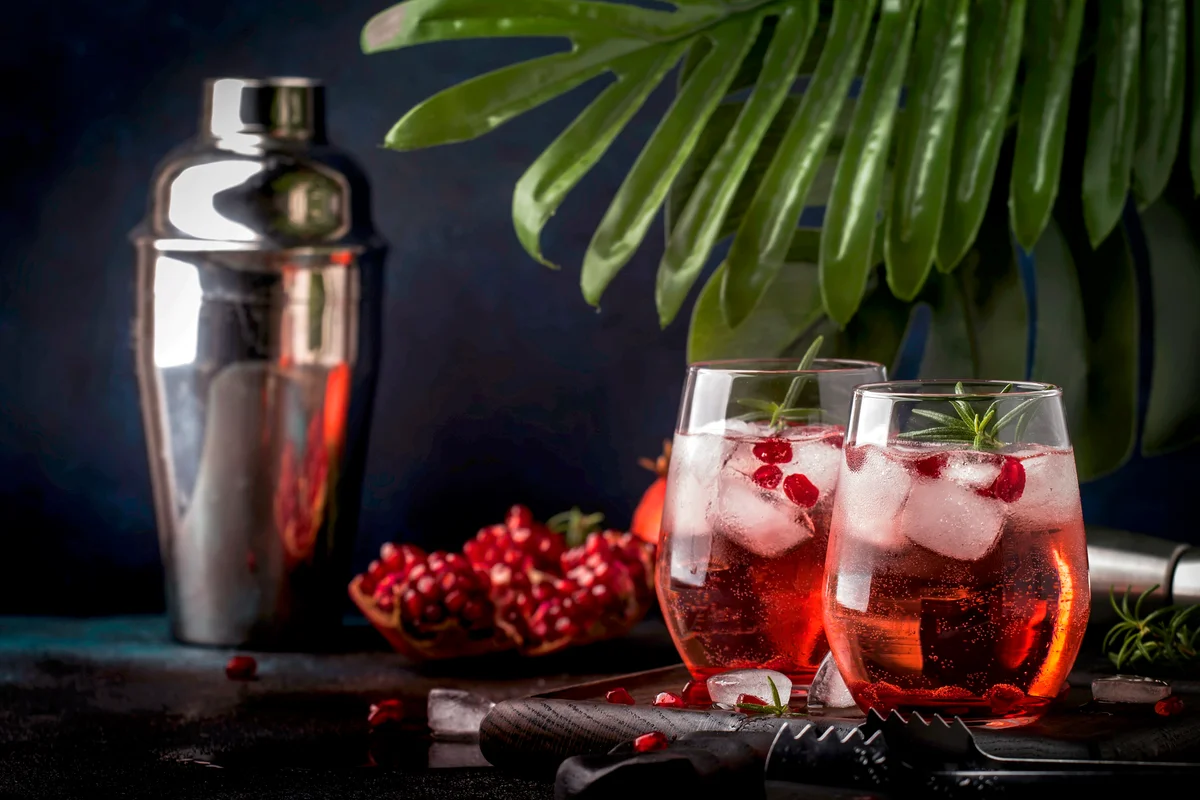 Red cocktail vodka pomegranate juice, with ice and rosemary