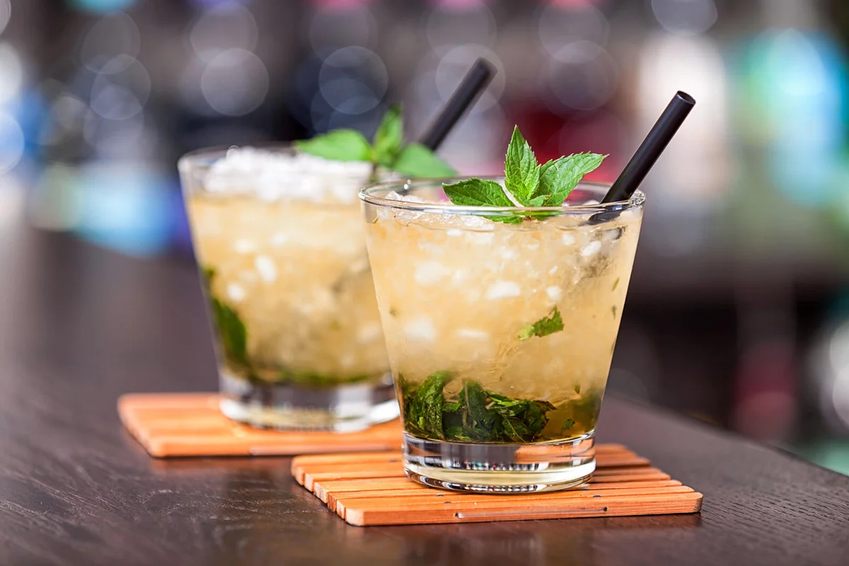 Two cocktails Mint Julep on a bar counter