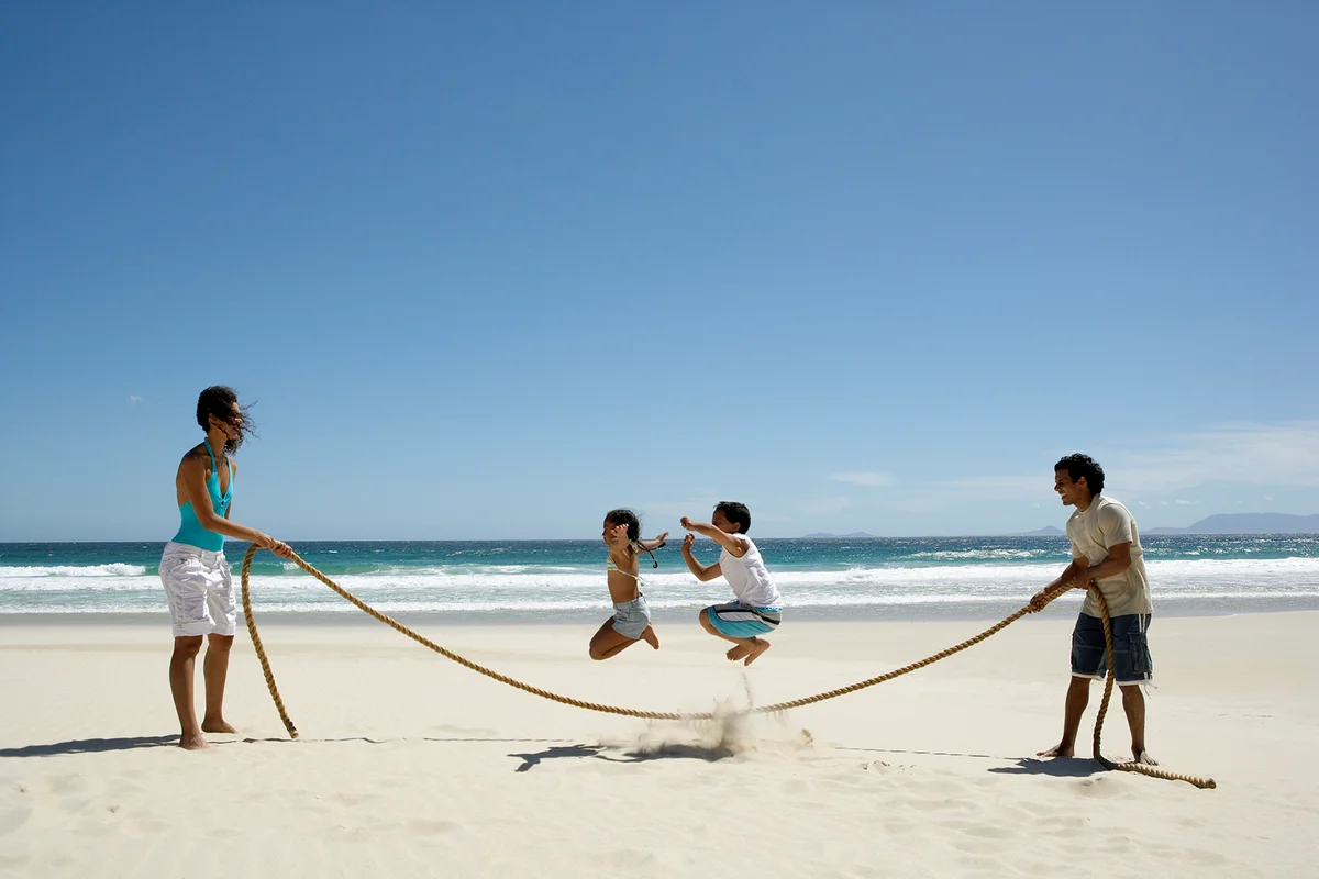 Family Jumping Rope on the Beach