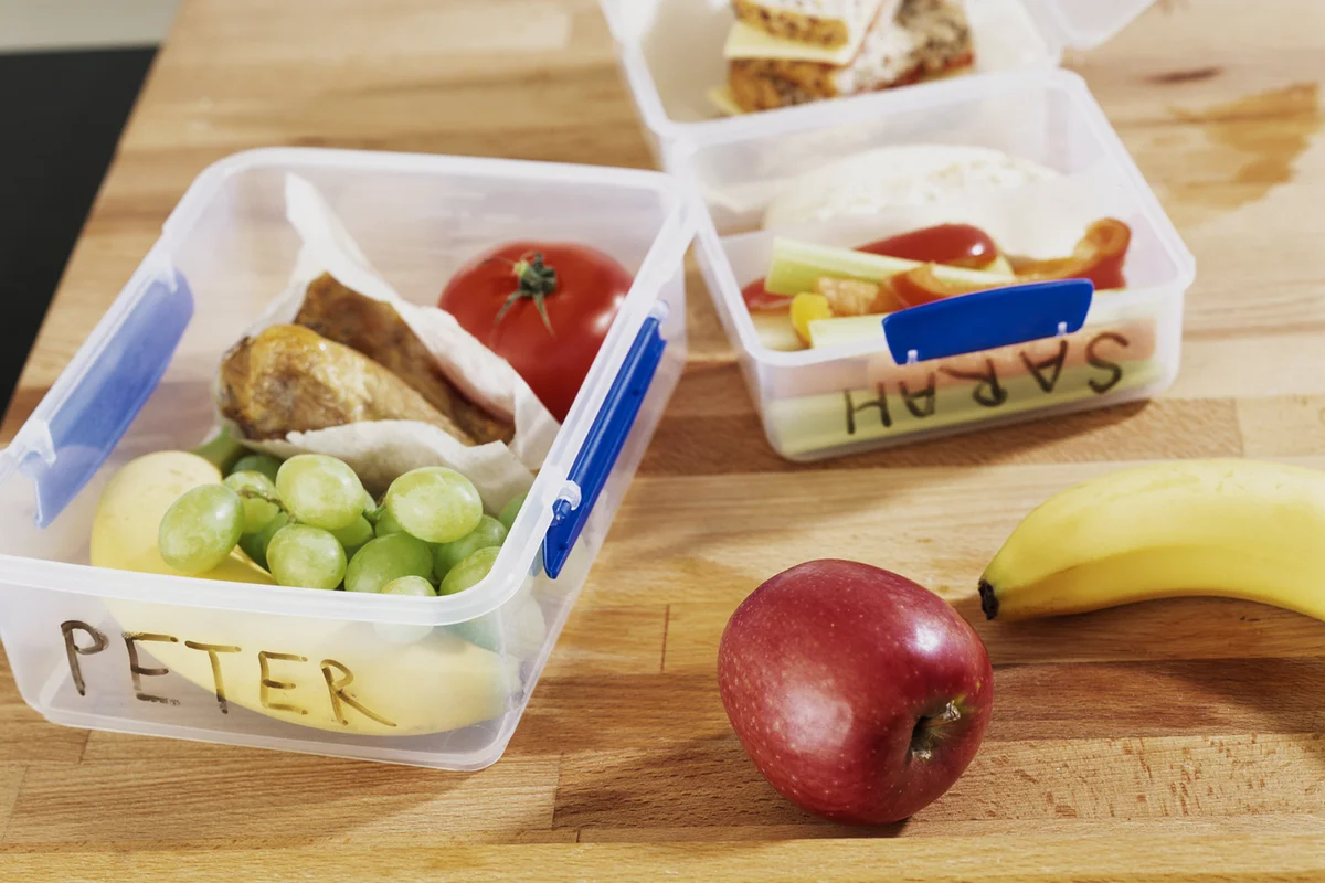 Named packed lunches on table
