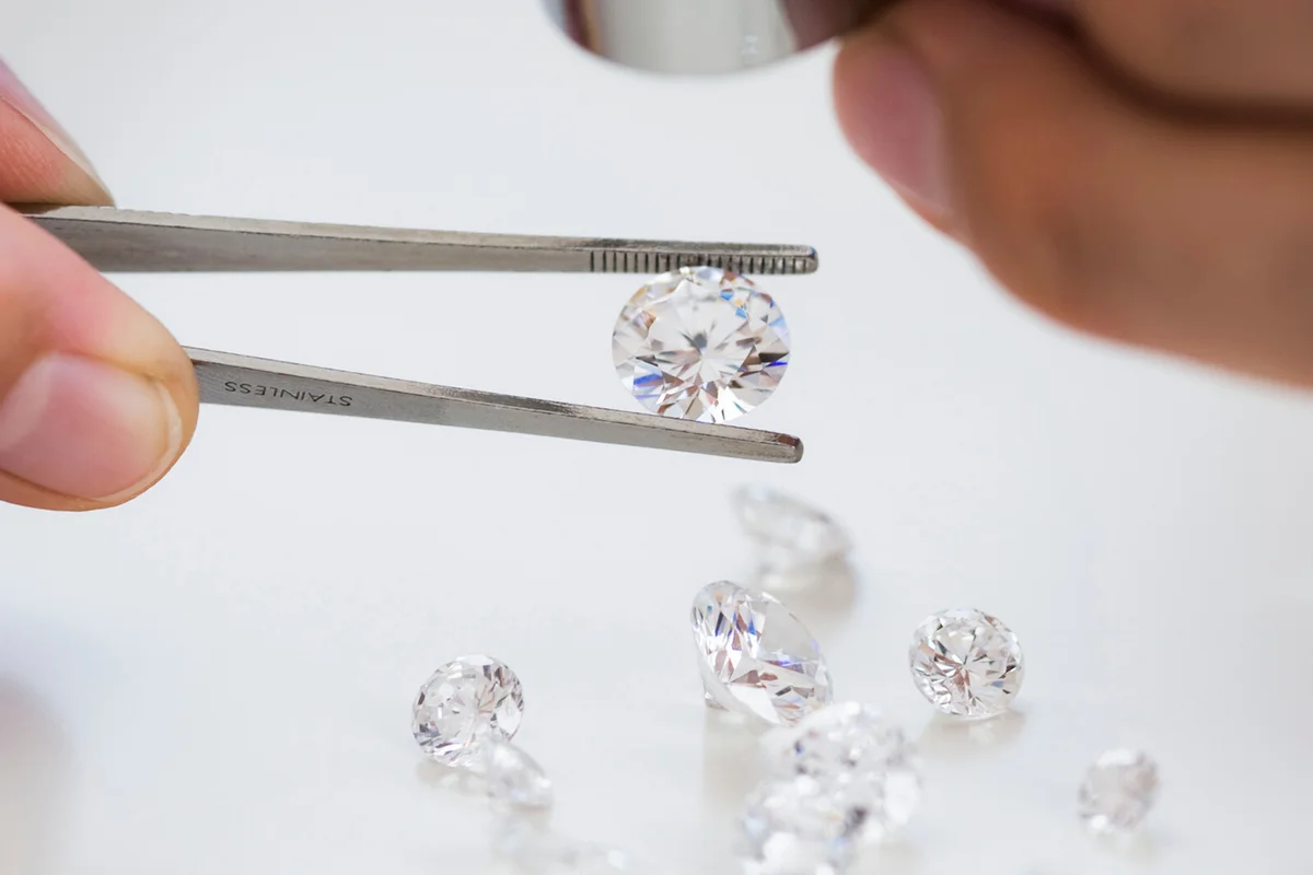 Gemologist inspecting diamonds using loupe