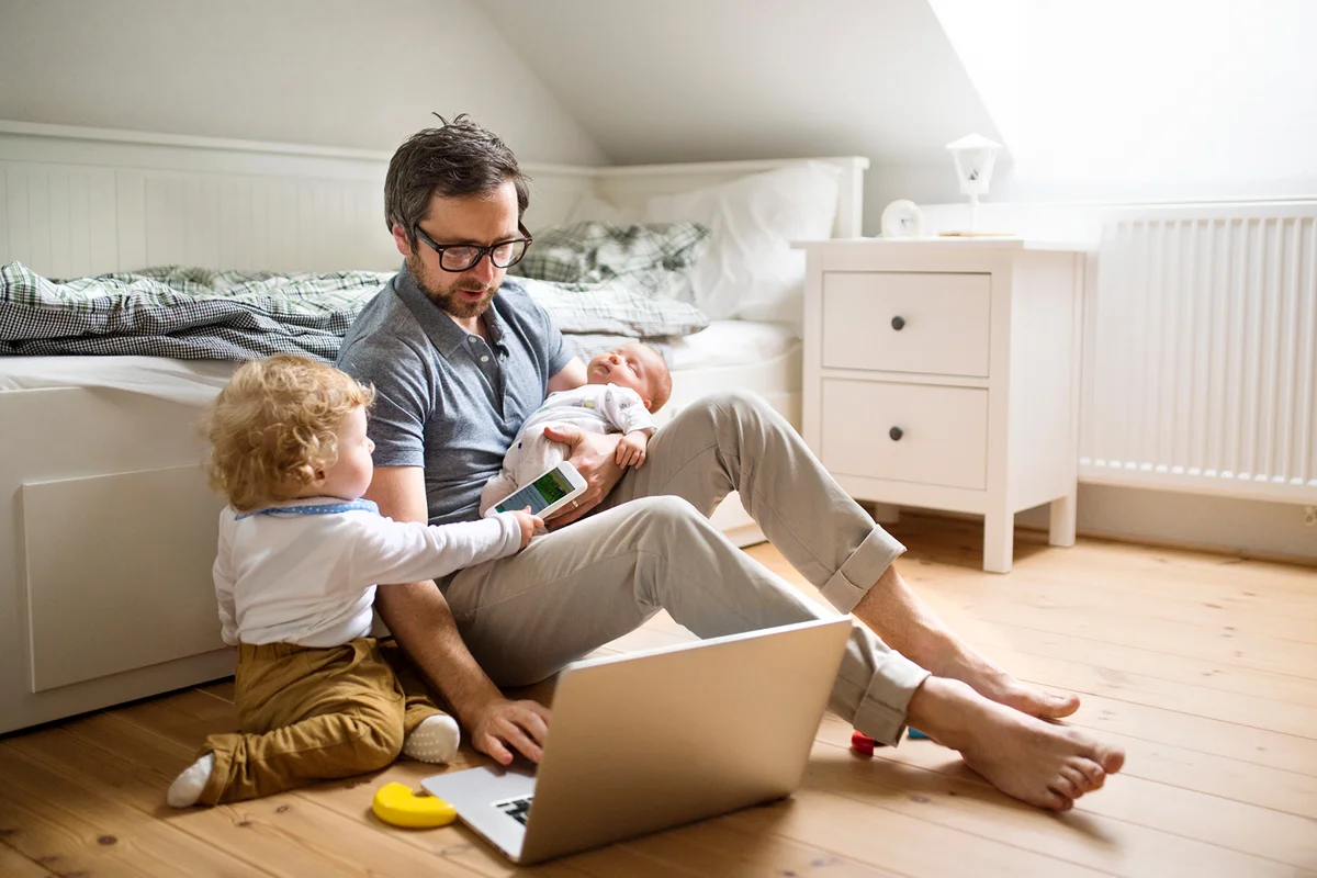 Father with his little son and baby daughter at home