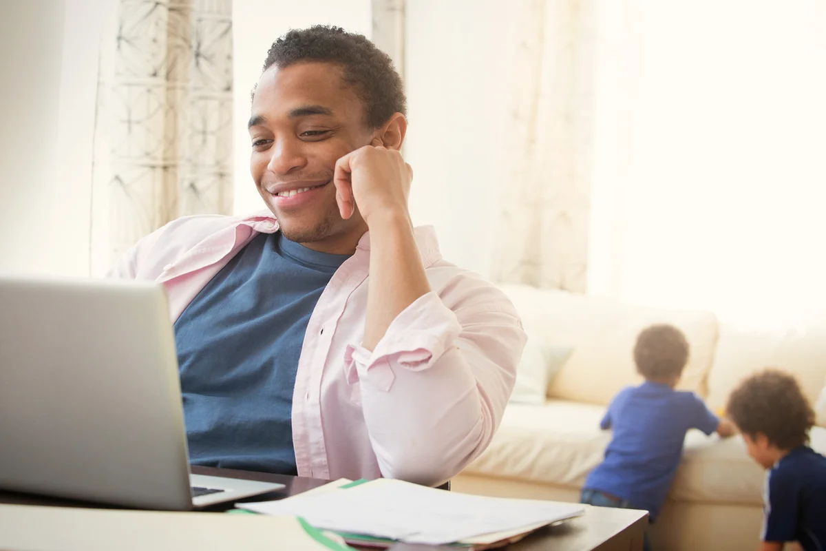 man using laptop in living room