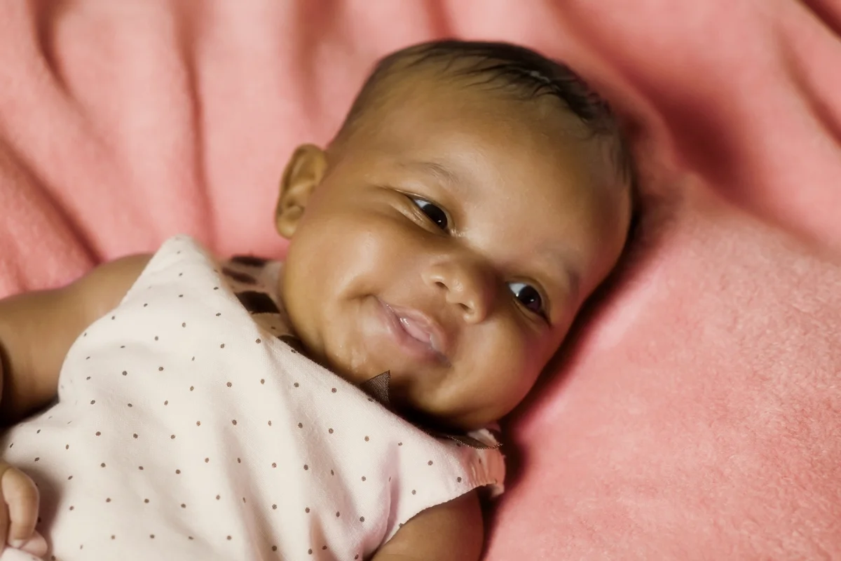 Newborn girl smiling
