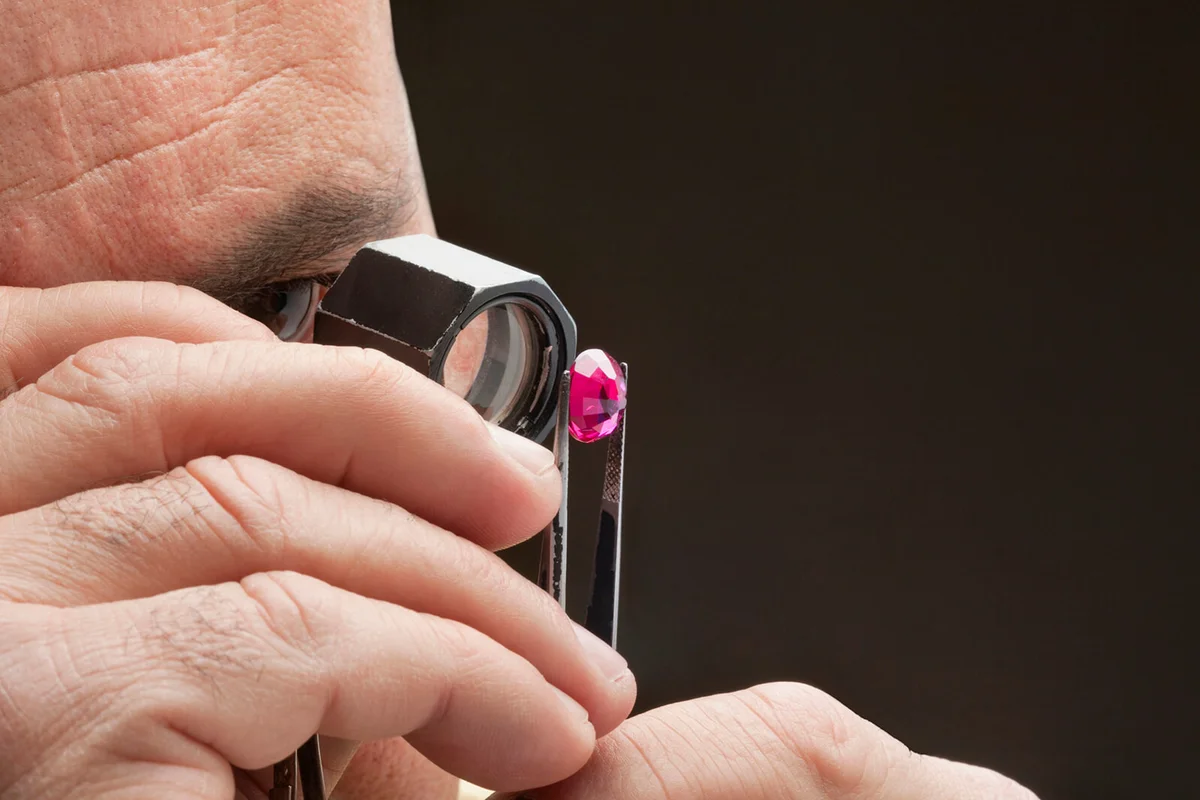 Cropped image of jeweler examining jewel
