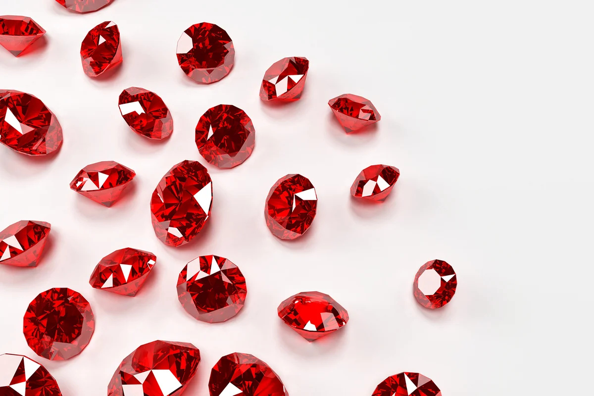 Many red rubies on a white surface