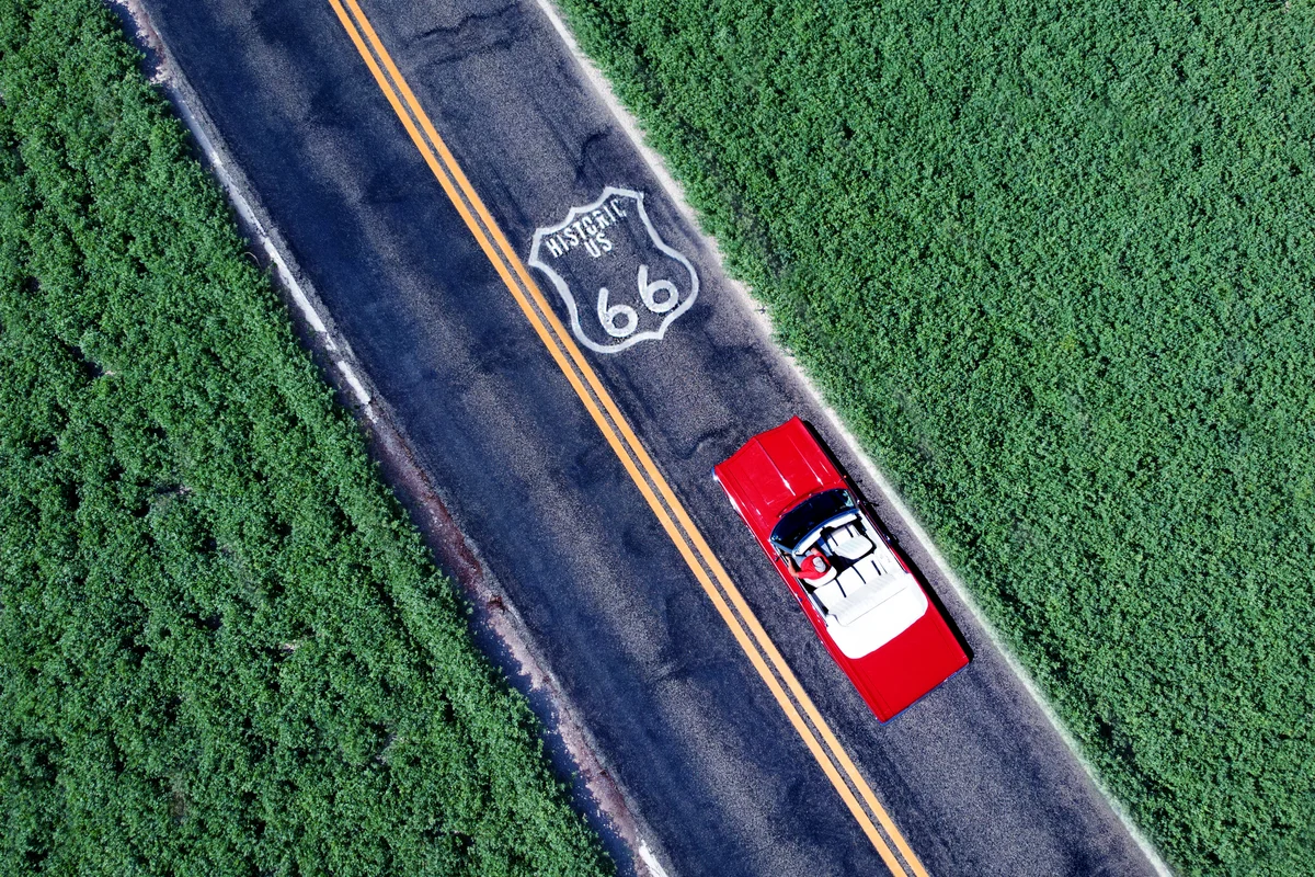 Red car heading down Route 66