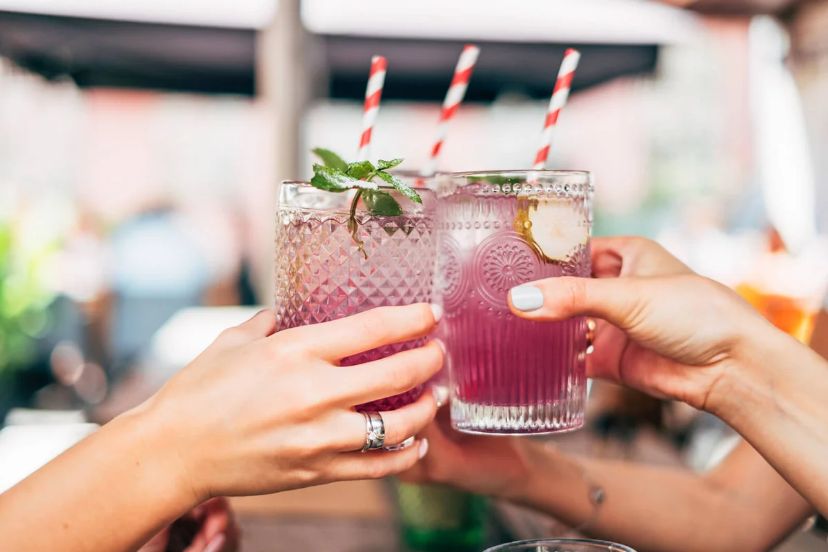 Three women making a celebratory toast