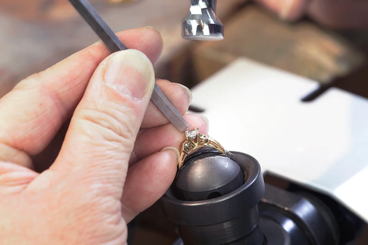 A Jeweller is Repairing a Diamond Ring