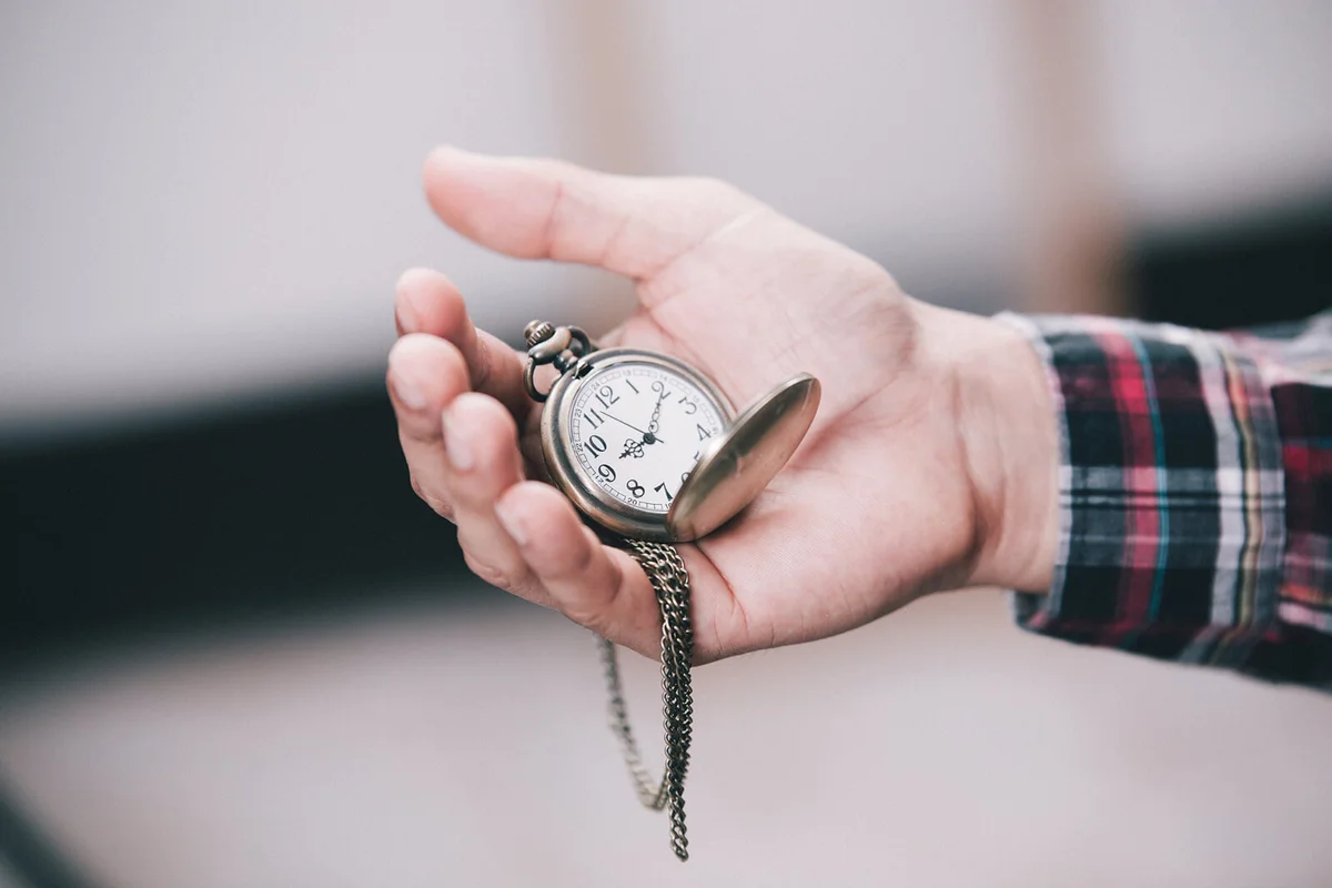 Man Holding Pocket Watch Outdoors