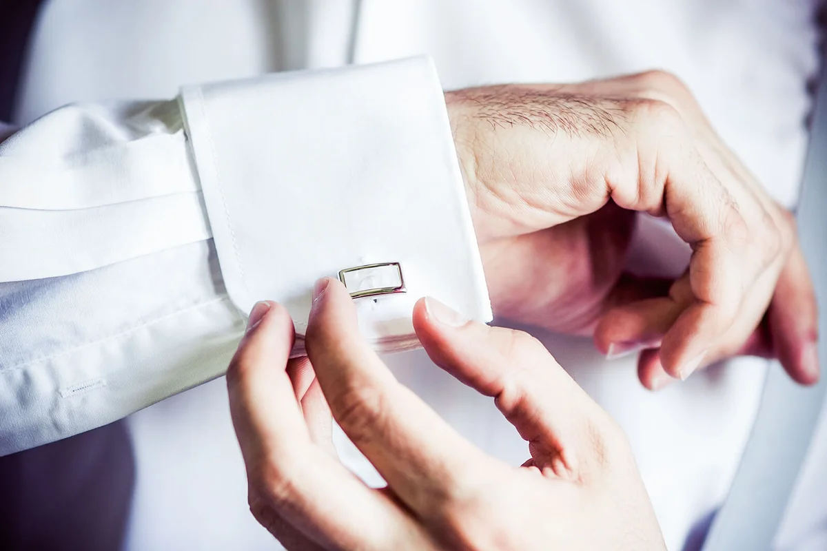Groom adjusting cuff links