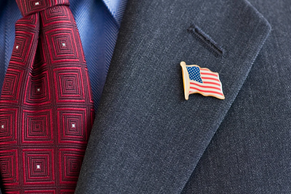 Business suit with pin of American flag on lapel