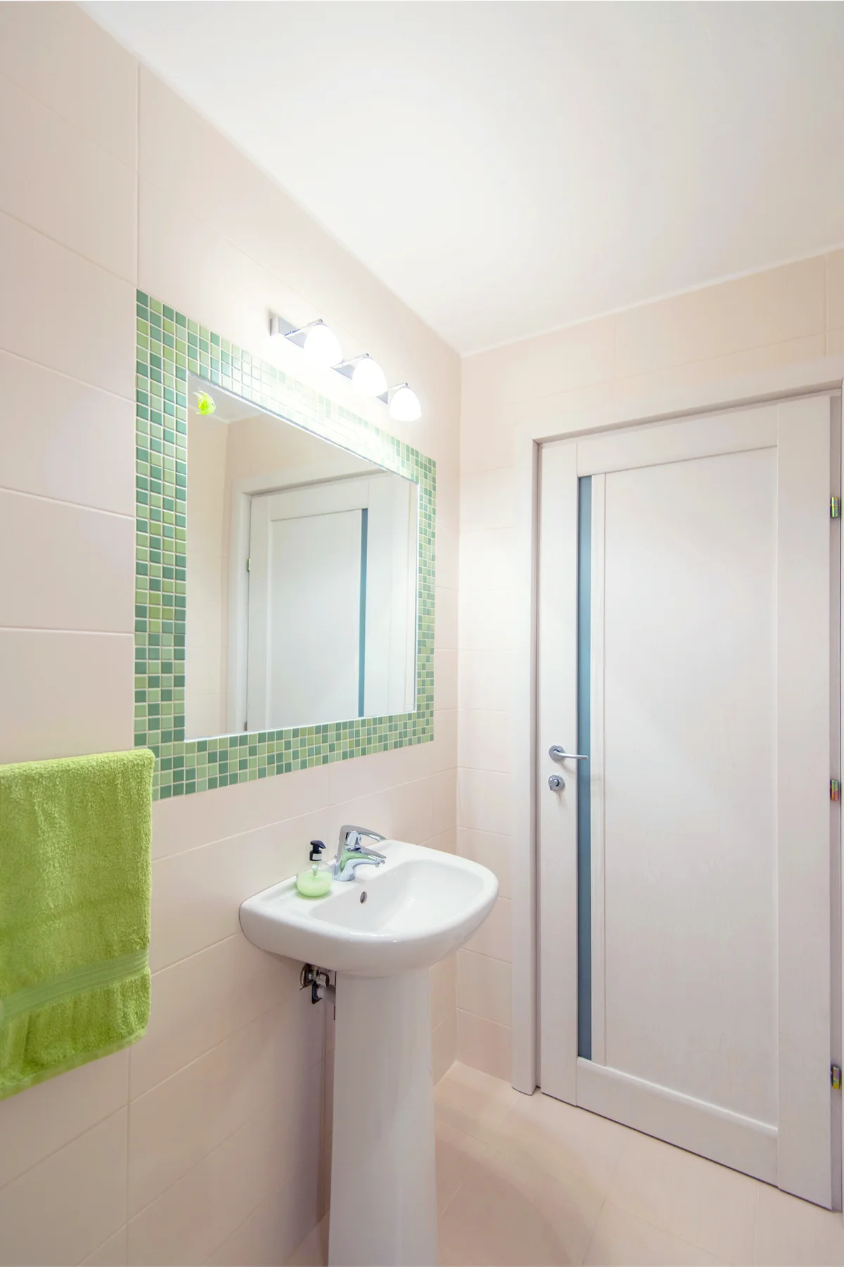 Modern bathroom decorated in green and cream colors