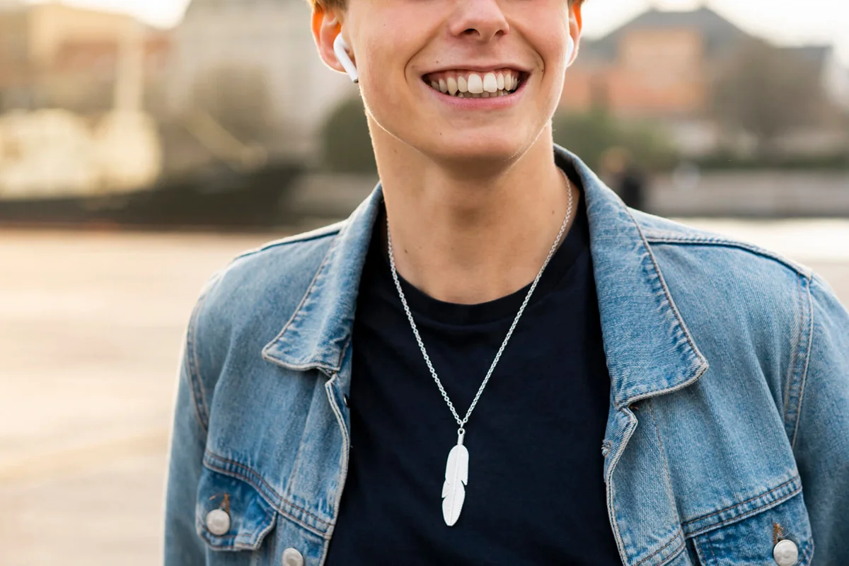 portrait of happy young man with earbuds in the city
