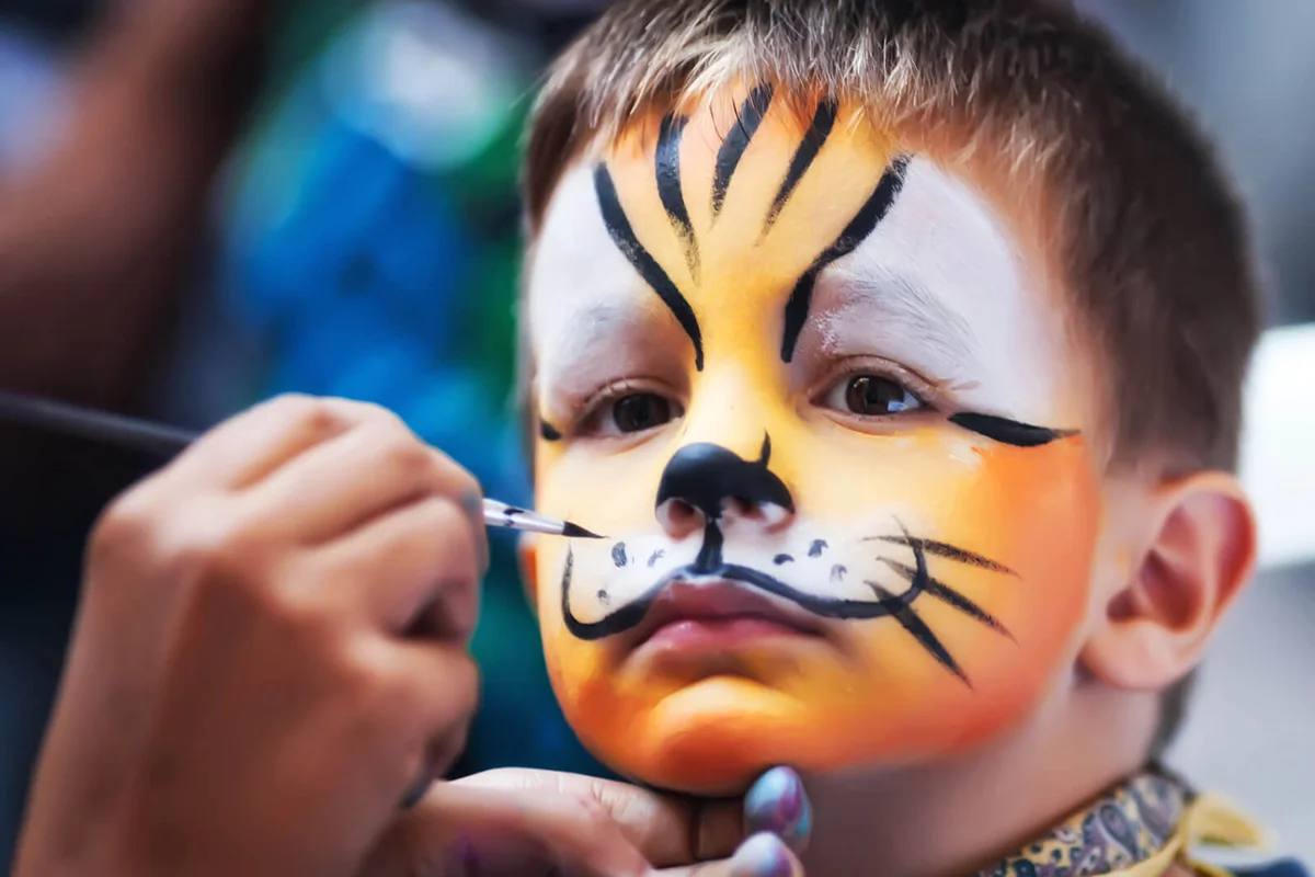 little cute boy while being masked as tiger