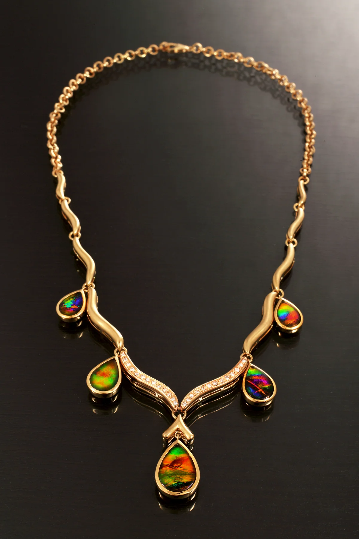 Gold chain necklace with precious intarsia gems, diamonds and emeralds