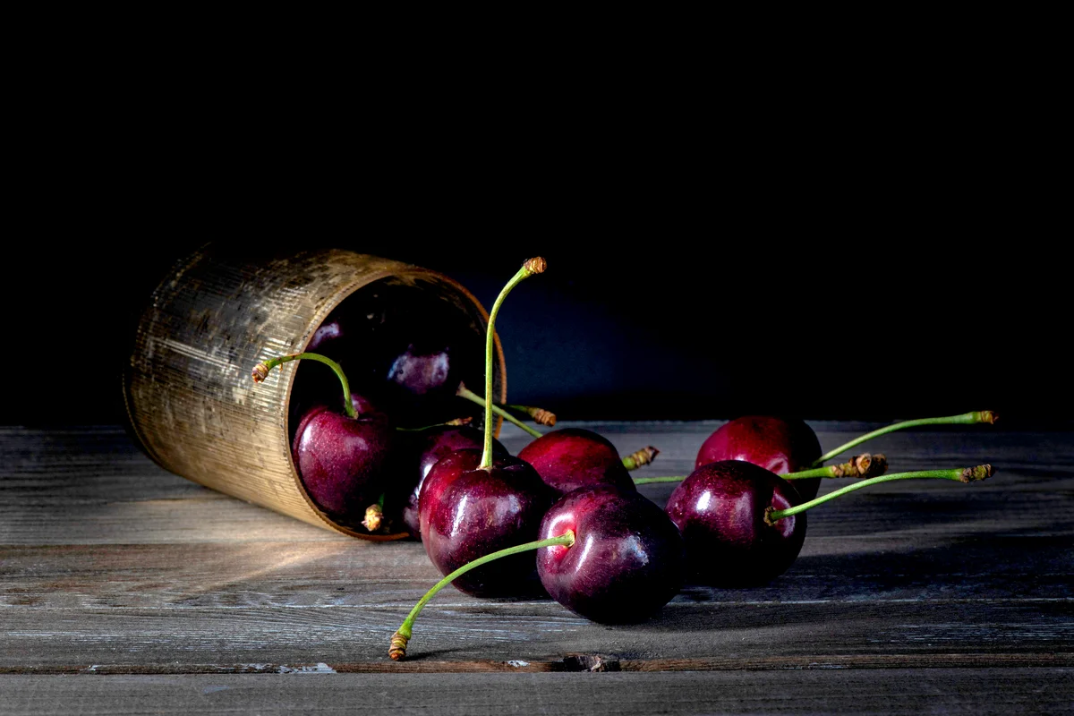 Dark cherries on rustic wood table top