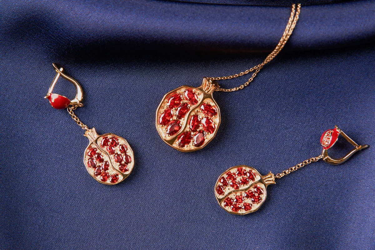 Ruby necklace and earrings on blue silk background