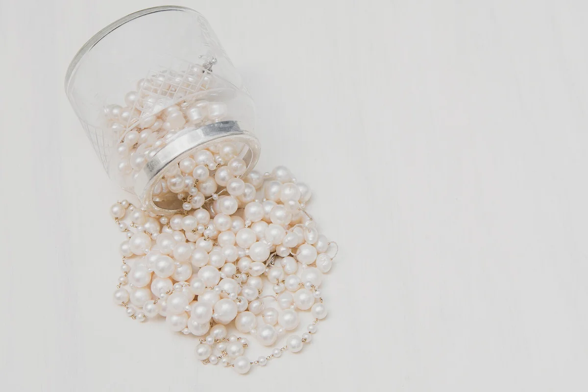 Many pearls coming out of a crystal box