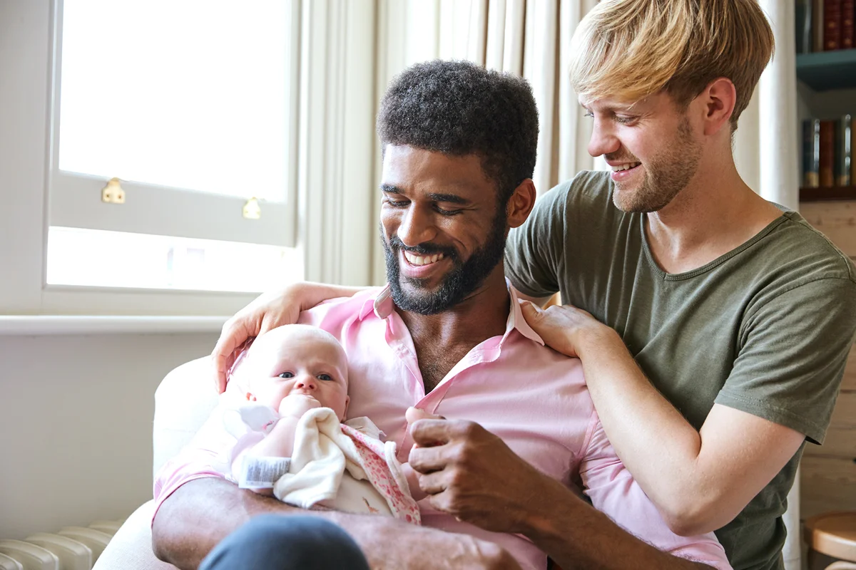 Loving Couple Cuddling Baby Daughter