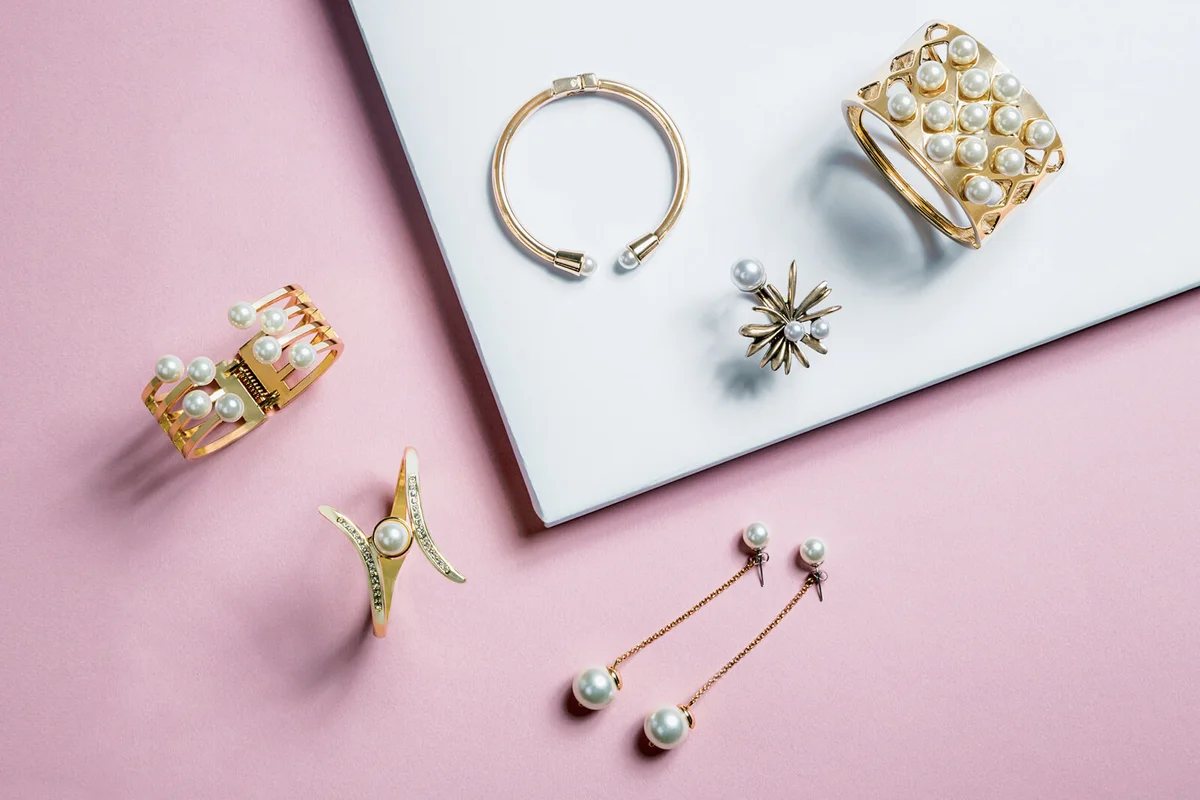 golden bracelets and earrings with pearls