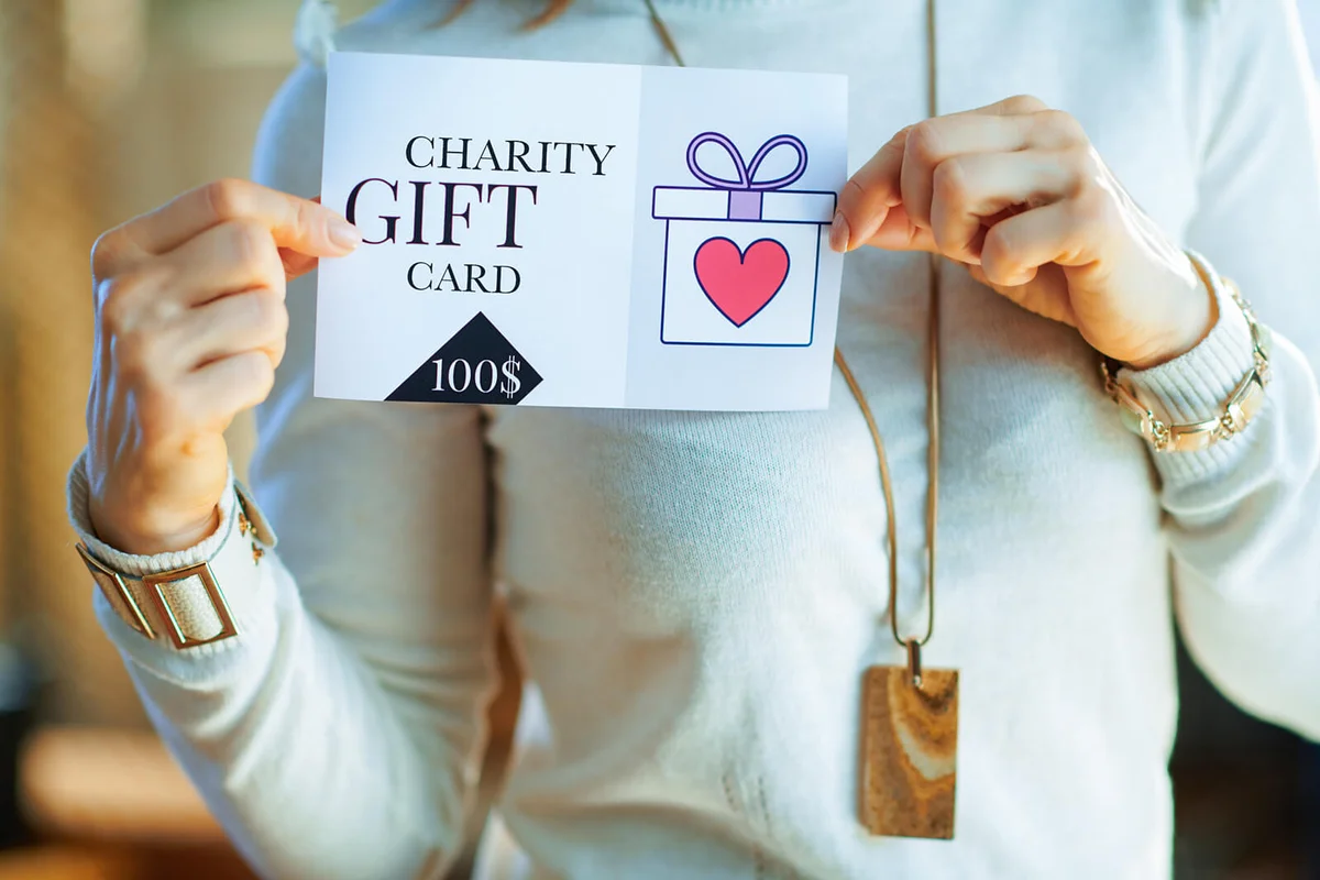 Closeup on elegant housewife holding gift certificate