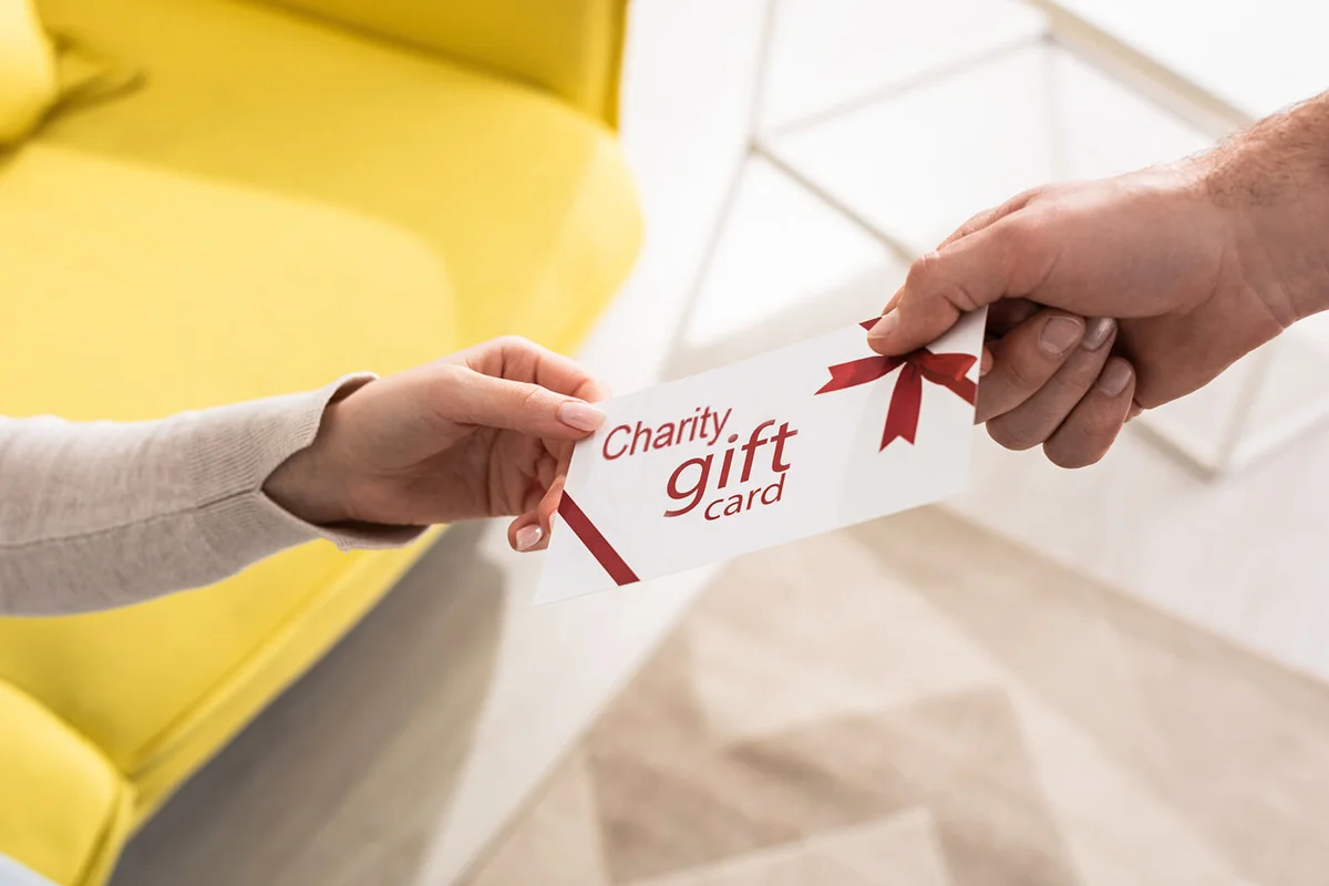 Cropped view of man giving gift card to girlfriend
