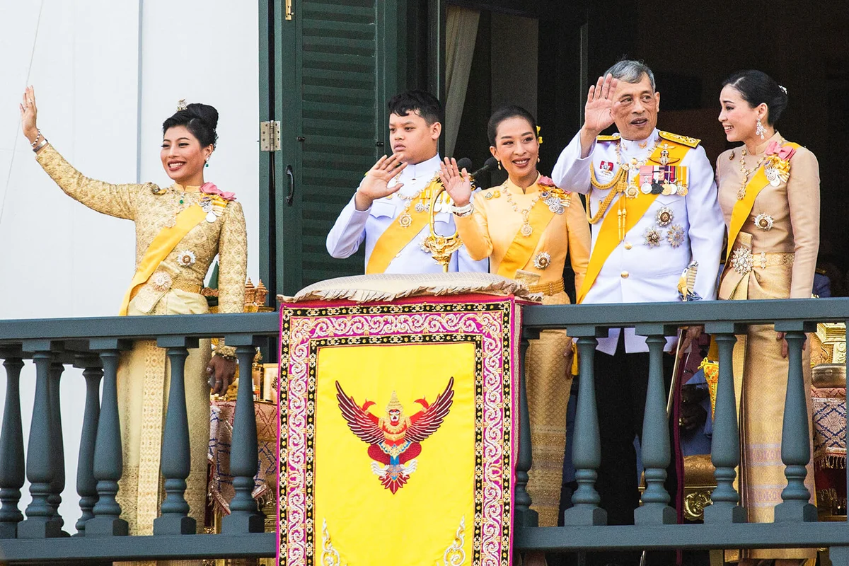 King Maha Vajiralongkorn and the Royal family wave to the public on a balcony of Suddhaisavarya Prasad Hall in the Grand Palace | Getty Editorial Use