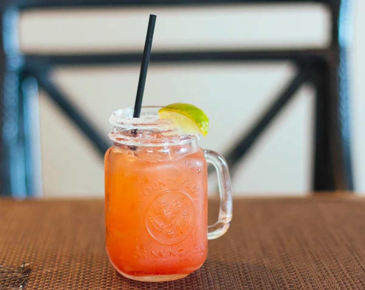 Tropical pink cocktail in mason jar